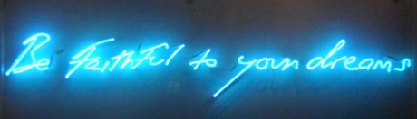 Neon phrase reading, "Be faithful to your dreams."