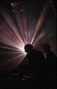 DJ backlit by streams of light